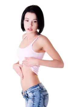 Young beautiful woman checking her fit belly