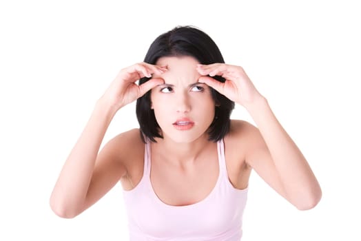 Beautiful shocked woman checking her first wrinkles on forehead