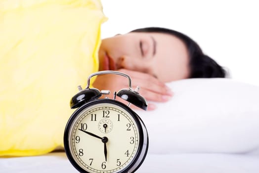 Alarm clock being placed on a nightstand in a bedroom