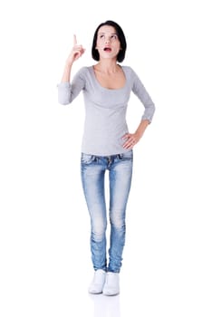 Surprised woman with opened mouth pointing up on copy space. Isolated on white background.
