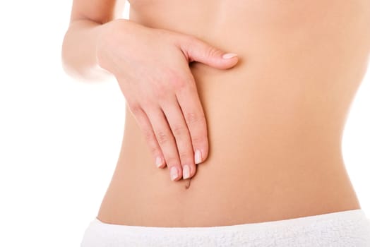 Hand on fit slim woman belly, isolated on white background