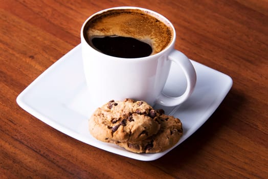 Coffee with cookie on table