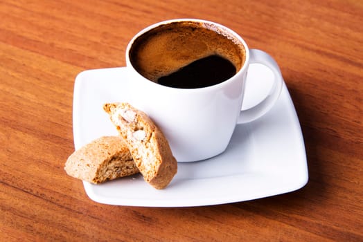 Coffee with cookie on table