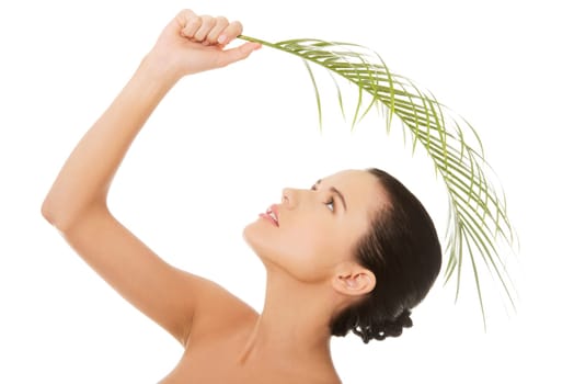 Portrait of young beautiful woman with green leaf