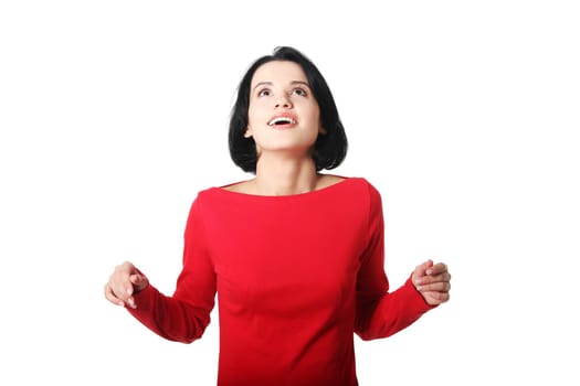 Shocked and excited woman looking up, isolated on white