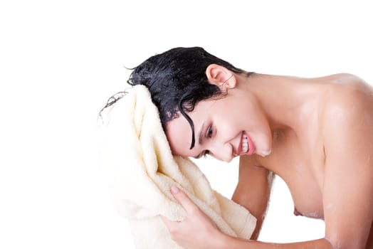 A young woman with wet hair in white robe toweling off after a shower.