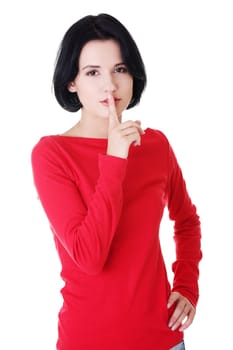 Woman making a keep it quiet gesture , isolated on white