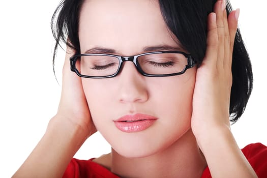 Closeup of frustrated young woman holding her ears, isolated on white