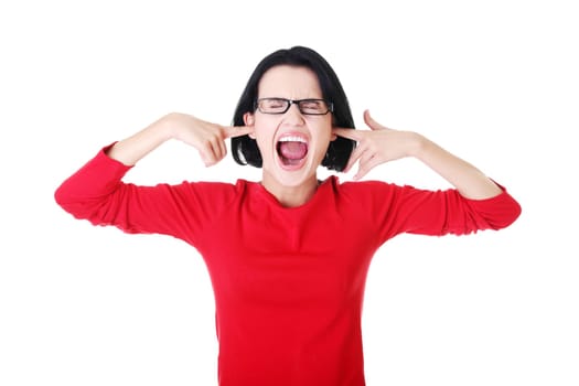 Closeup of frustrated young woman holding her ears, isolated on white
