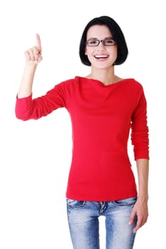 Happy , excited young woman pointing on copy space, isolated on white