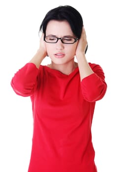 Closeup of frustrated young woman holding her ears, isolated on white