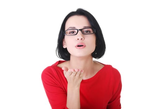 Young woman blowing a kiss on white background