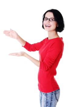 Happy , excited young woman presenting copy space on her palm, isolated on white