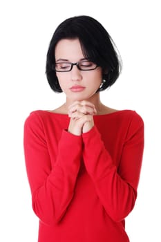 Closeup portrait of a young caucasian woman praying