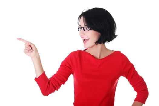 Happy , excited young woman pointing on copy space, isolated on white