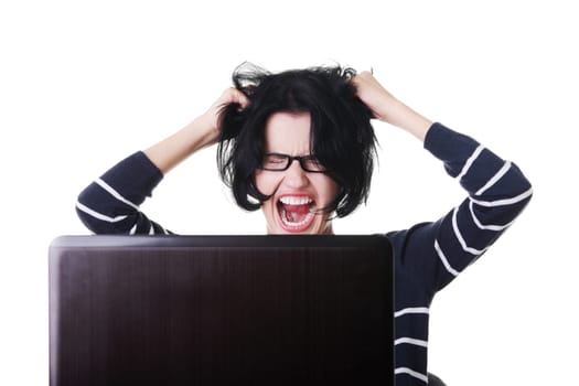 Frustrated woman working on laptop, isolated on white