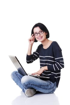 Happy young woman using her laptop, isolated on white.