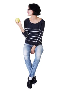 Young woman holding green fresh apple in hand, isolated over white background