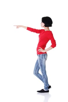 Happy , excited young woman pointing on copy space, isolated on white