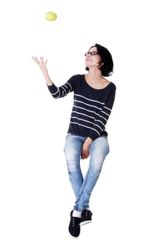 Young woman holding green fresh apple in hand, isolated over white background