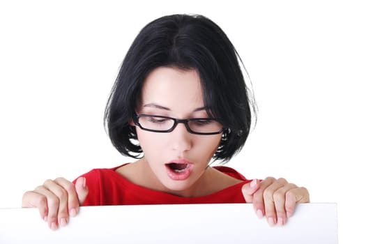 Shocked woman holding blank board, isolated on white