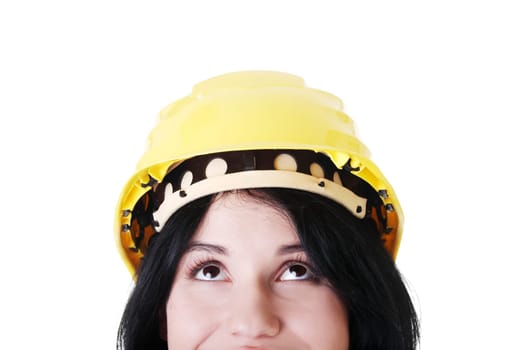 Portrait of confident female worker in helmet looking up. Isolated on white
