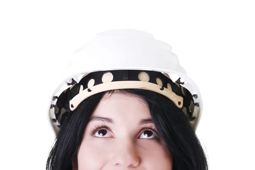 Portrait of confident female worker in helmet looking up. Isolated on white