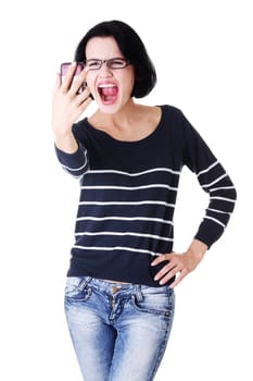Teen girl using cell phone- yelling angry, isolated on white