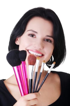 Young make-up artist woman holding brushes , isolated on white