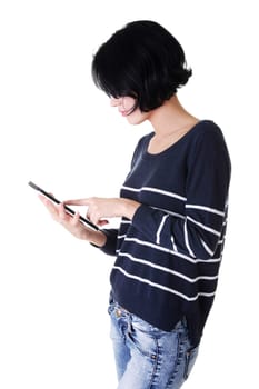 Young pretty woman working on tablet computer, isolated on white