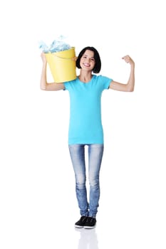 Beautiful young woman holding recycling bin isolated on white background.