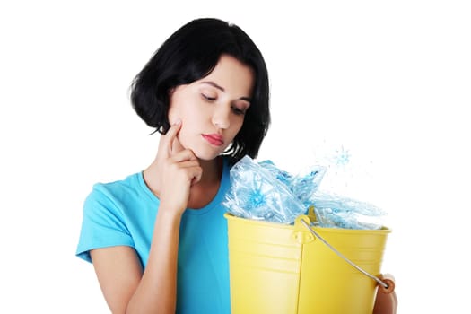 Young woman carrying a container full of empty recyclable plastic. Recycling concept