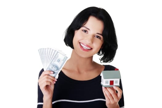 Beautiful young woman holding US dollars bills and house model over white - real estate loan concept