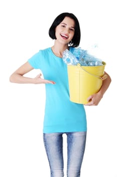 Beautiful young woman holding recycling bin isolated on white background.