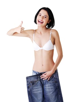 Young happy fit woman with big pants
