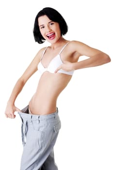 Young fit woman showing how much weight did she lost. Isolated on white