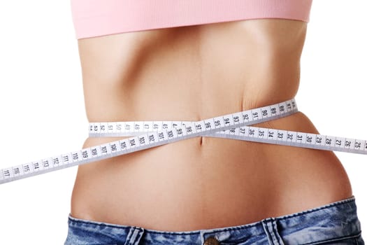 Young woman measuring her waist