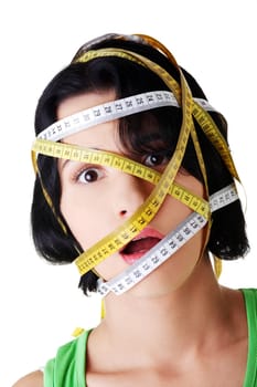 Beautiful young caucasian woman with measuring tape around her head