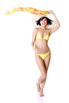 Sexy brunette woman posing in yellow bikini