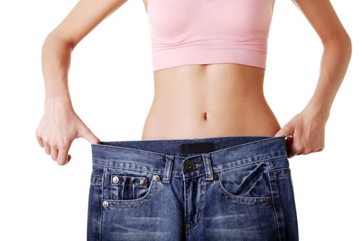 Fit woman with big pants , isolated on white