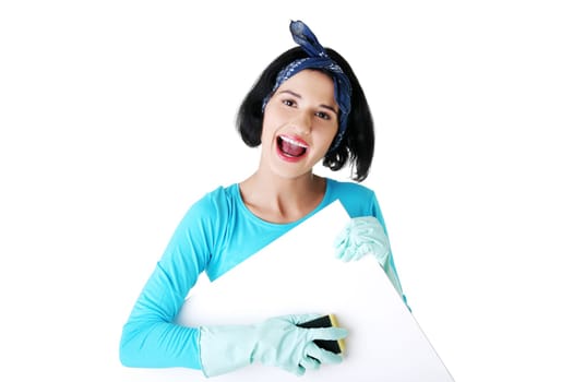 Smiling happy cleaning woman showing blank sign board.