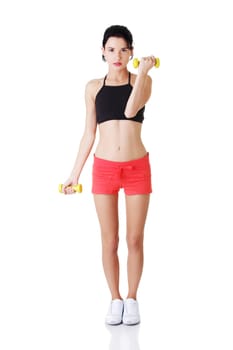 Fitness girl is working out with dumbbells , isolated on white background
