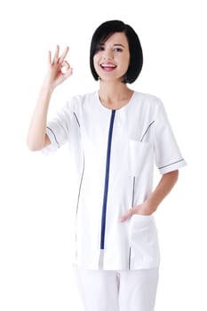 Young female doctor or nurse gesturing perfect . Isolated