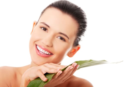 Portrait of young beautiful smiling woman with green leaf . Spa treatment concept