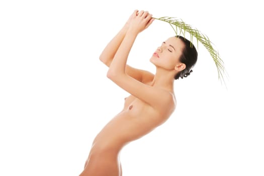 Portrait of young beautiful naked woman with green leaf