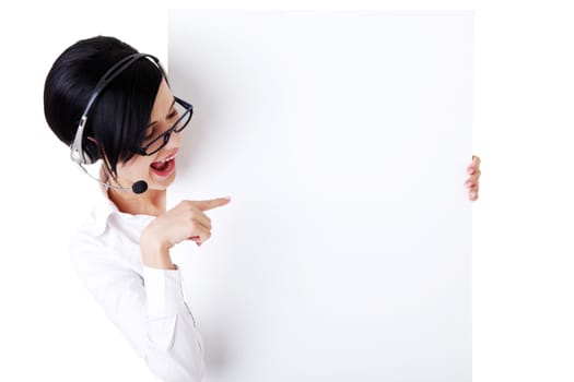 Pretty young call center worker wearing a headset and holding blank sign board