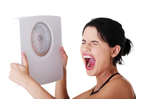Frustrated woman with scale, isolated on white