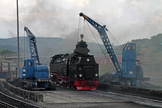 Steam locomotive is loaded with coal