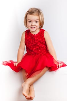 Beautiful little girl in red dresses