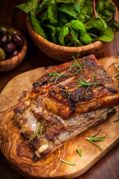Roasted pork with olives and salad